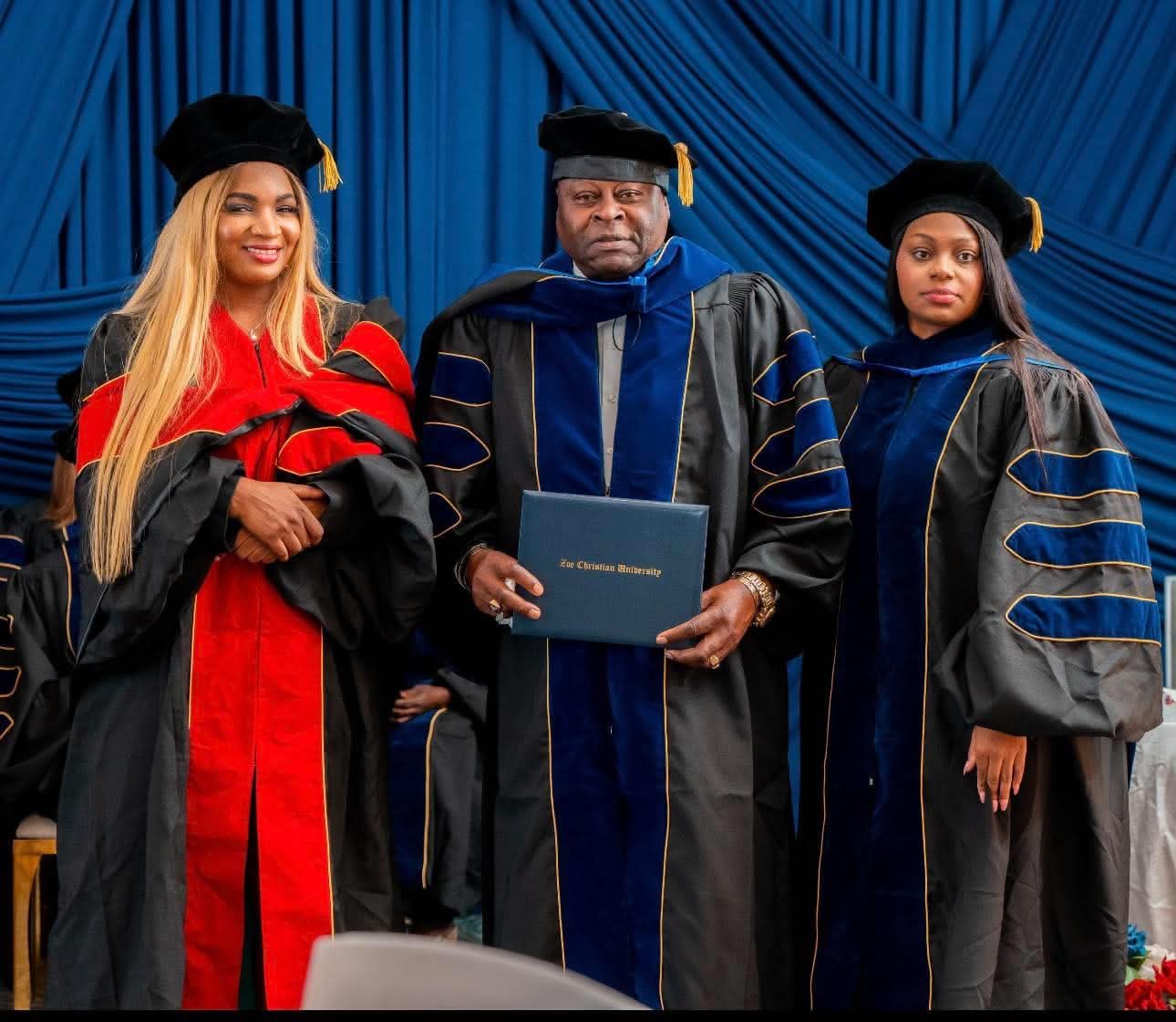 Zoe Christian University graduates holding diploma folders