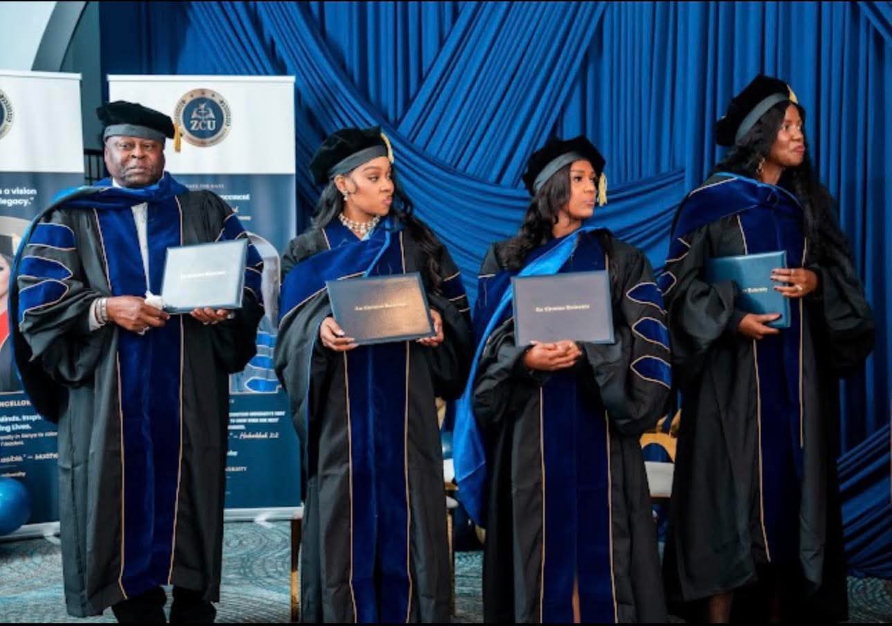 Graduates standing in a line holding their Zoe Christian University diplomas