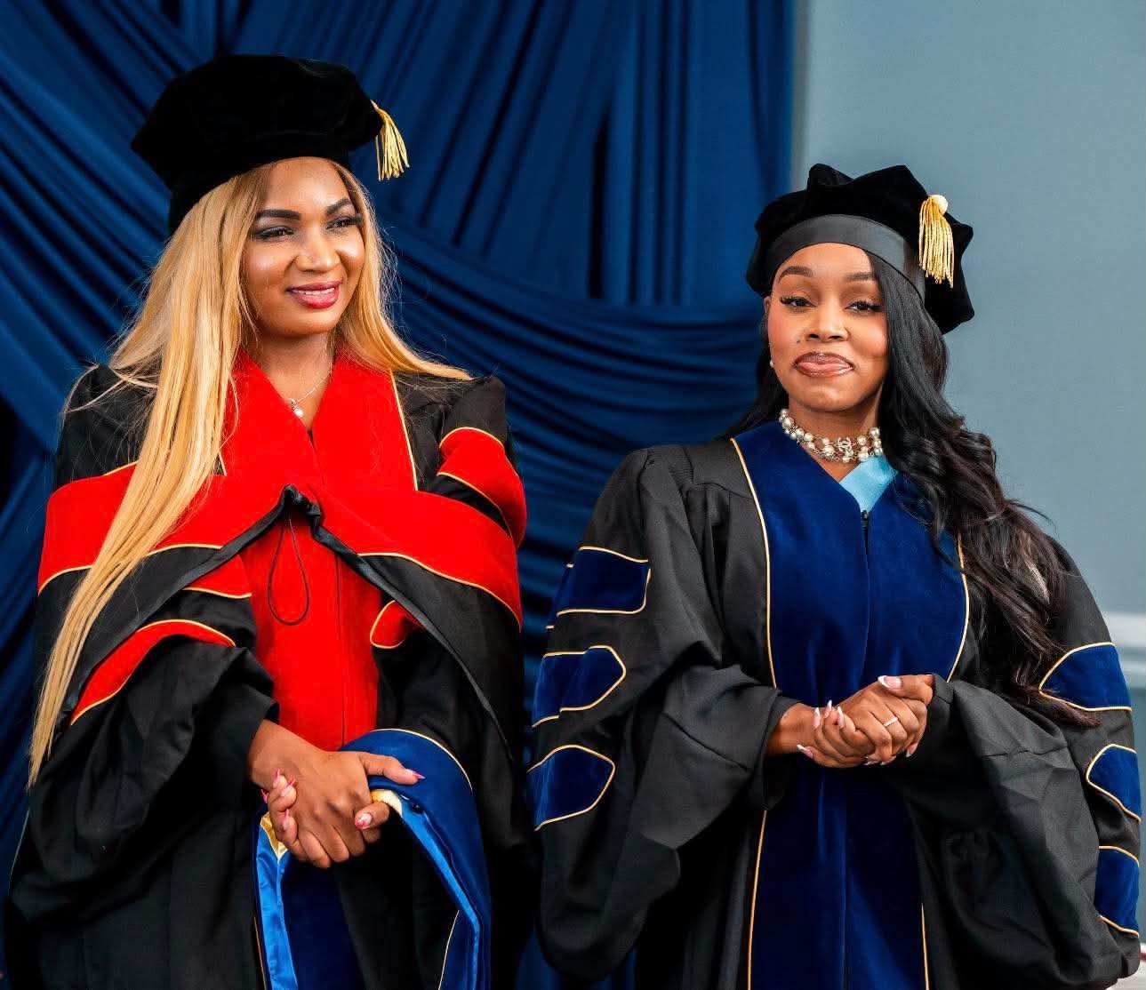University leader and graduate standing together in regalia