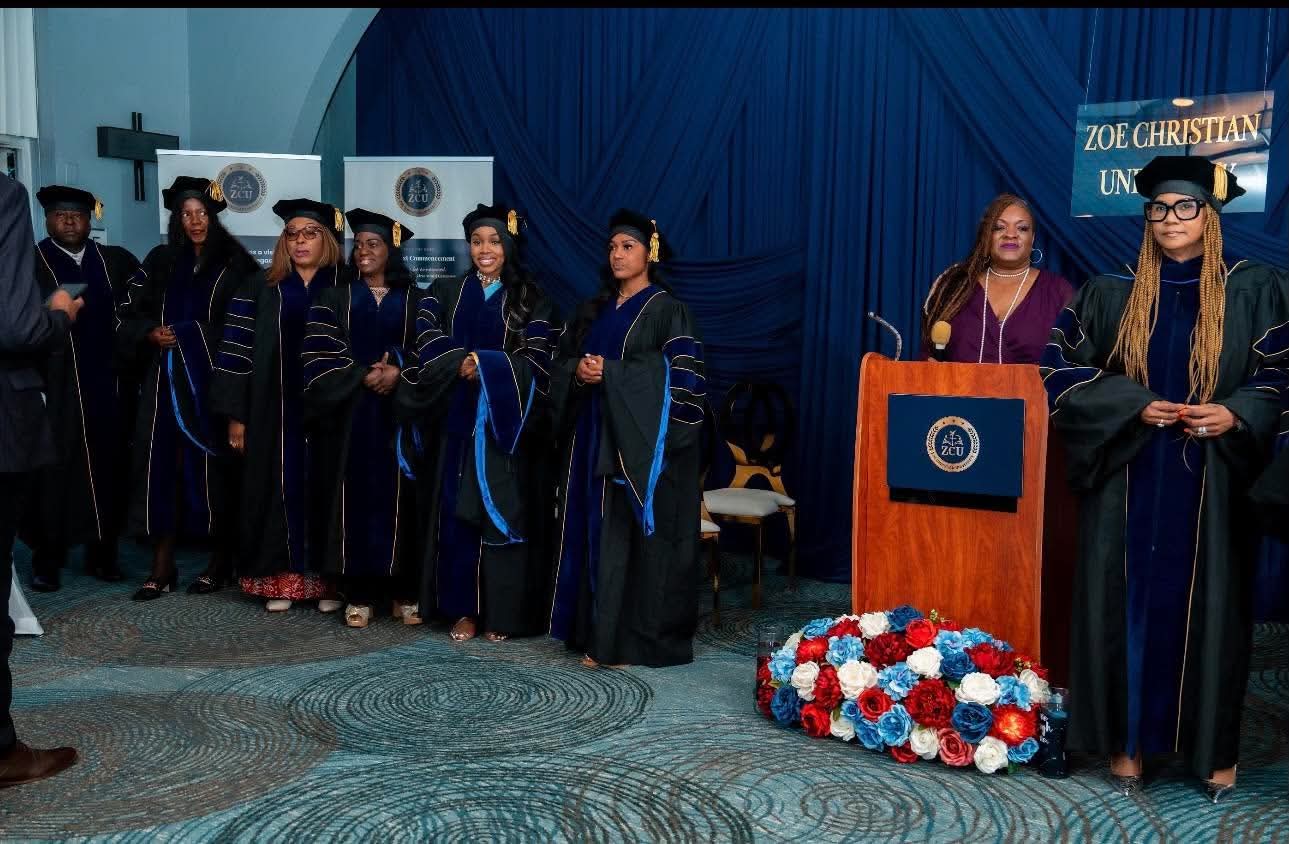 Zoe Christian University graduates gathered near the commencement podium